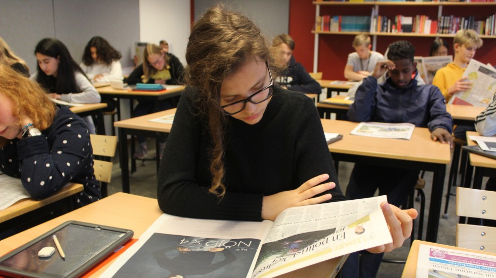 Klass 7C på Ånestadsskolan studerar morgontidningen. Längst fram sitter Minna Evaldsson.