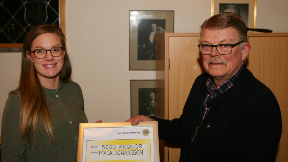 Maja Johansson tar emot utmärkelsen "Årets eldsjäl" av Per Samuelsson, president i Lions Club, Vimmerby.