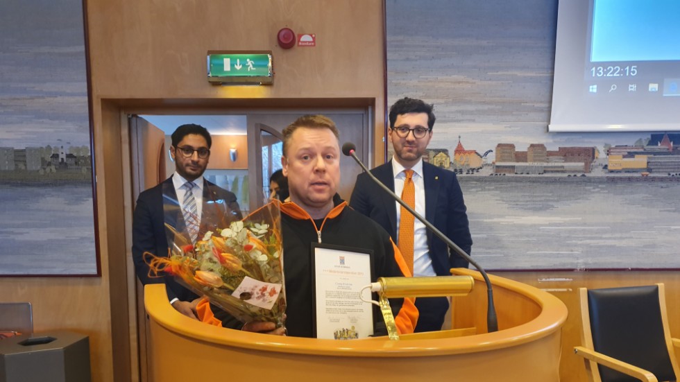 Conny Broström prisades vid kommunfullmäktige i Luleå. I bakgrunden Daniel Smirat (S), vice ordförande i kommunfullmäktige, och Nihad Zara (M), ordförande i fullmäktige.