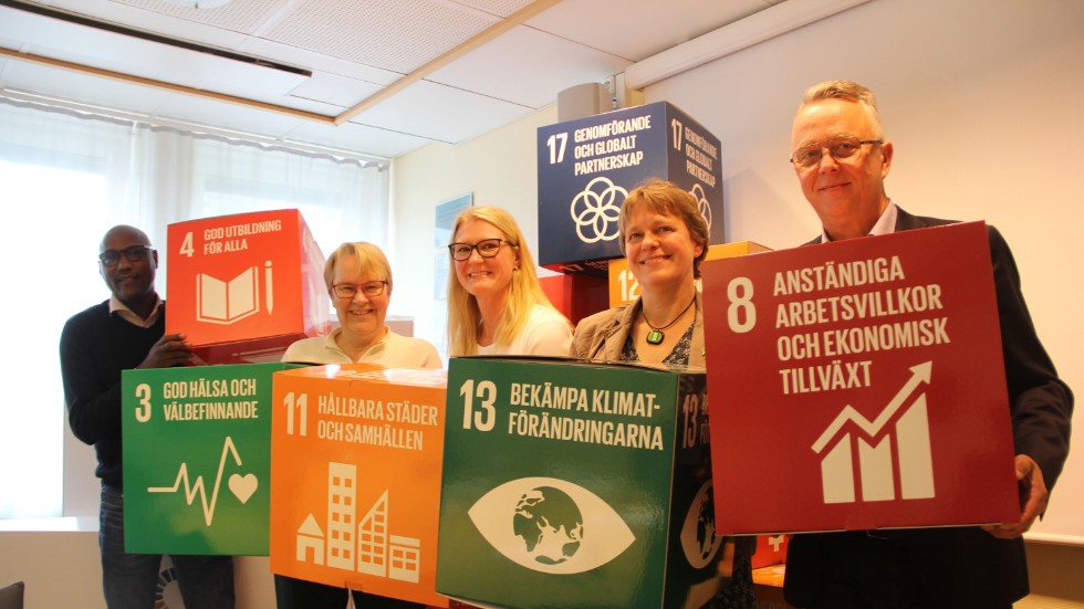 Kvintetten från vänster; Alfred Mujambere (L), Ann-Kristin Ringefors (KD), Sara Sjödal (C), Jenny Lundström (MP) och Lars-Göran Birkehorn Karlsen har lagt fram ett budgetförslag som utgår från FN:s 17 agenda 2030-mål. Några av dessa visar de upp här.