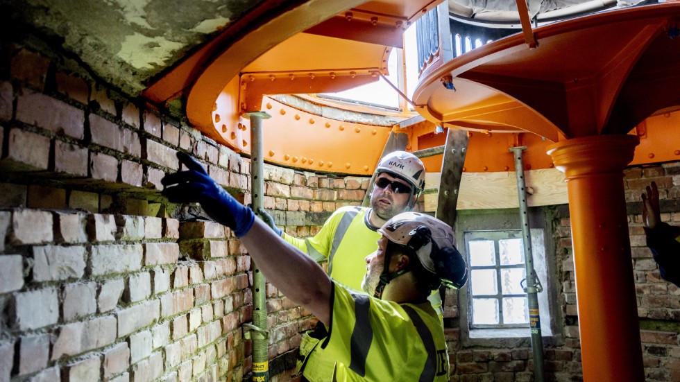 Przemyslav Karsas och Niklas Orava inspekterar renoveringen av Tistlarnas fyr. Under projektets gång hyr byggjobbarna in sig i ett av husen på ön.