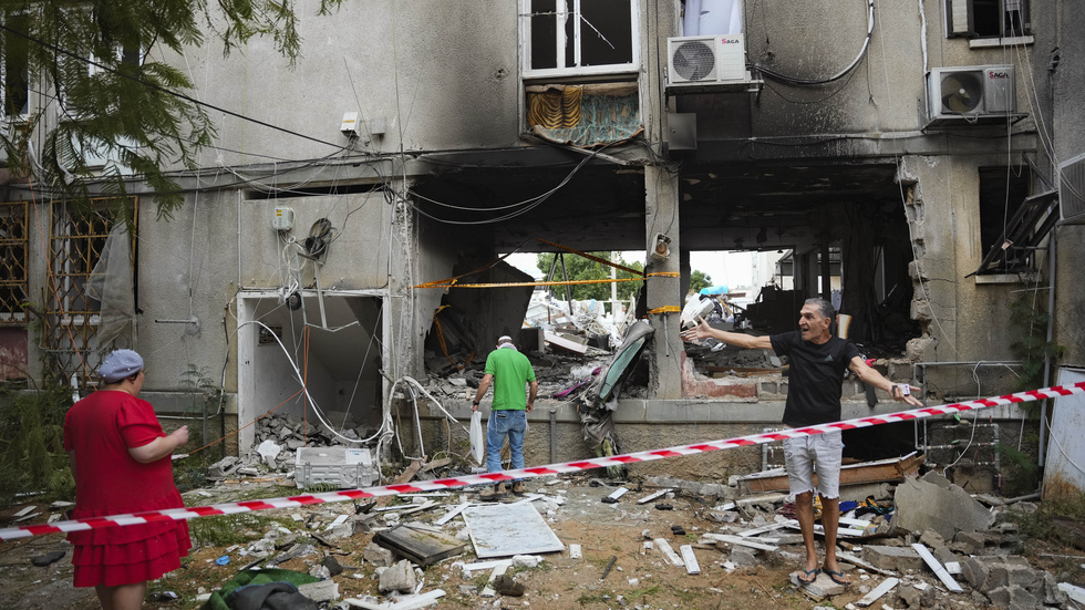 Israeler inspekterar en skadad byggnad i staden Ashkelon.