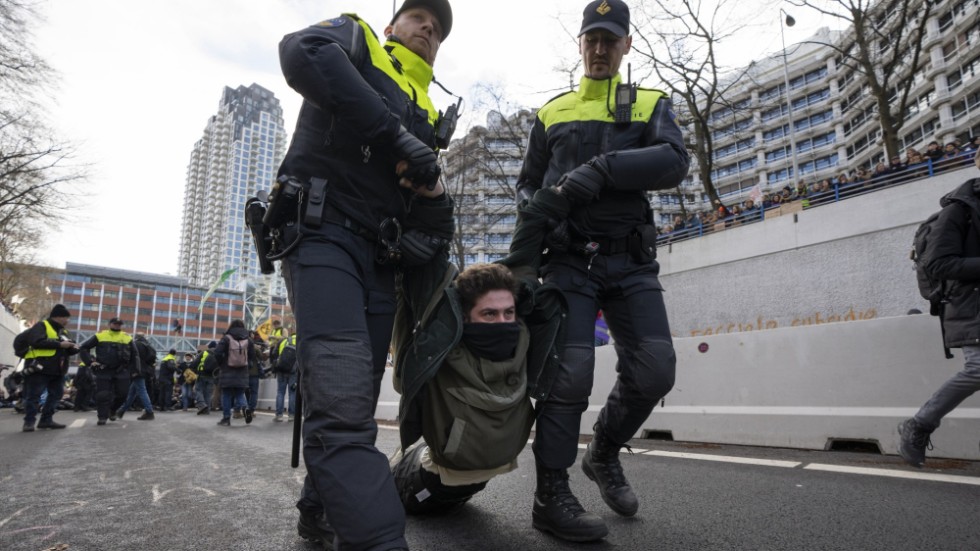 An Extinction Rebellion activist is arrested by police during a climate demonstration in the Netherlands.