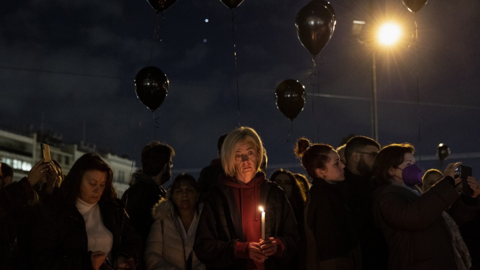 Demonstranter håller en tyst minut framför parlamentet i Aten under fredagskvällen. Tusentals protesterade i huvudstaden.