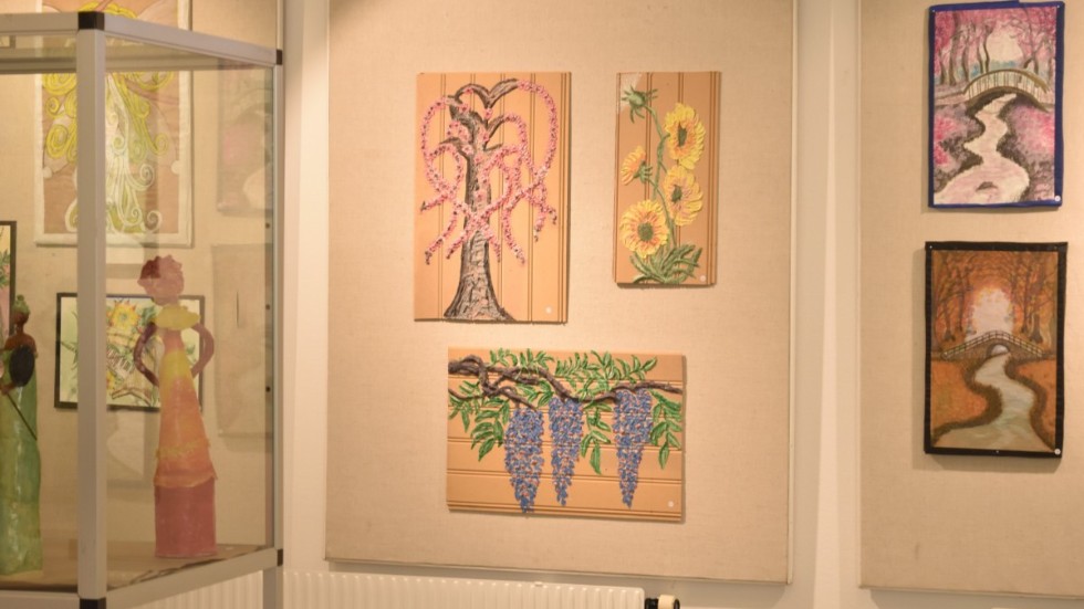 Minka Eriksson arbetar med återbruk. I mitten av bilden syns tavlor som hon målat på panel som hon tog hand om när ett av hennes barn renoverade sitt badrum.