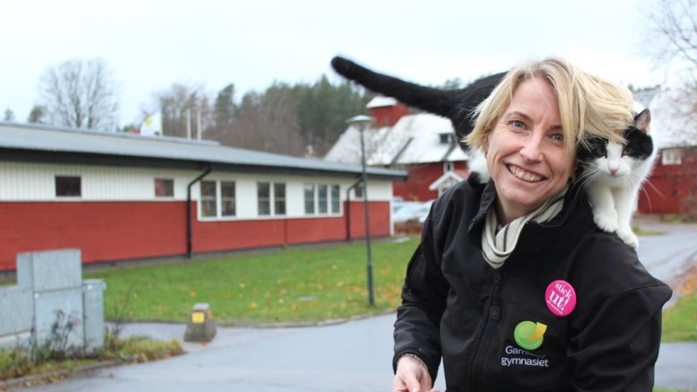Sofie Alvarsson, rektor för Gamlebygymnasiet, med en okänd katt, som hälsar på ibland.