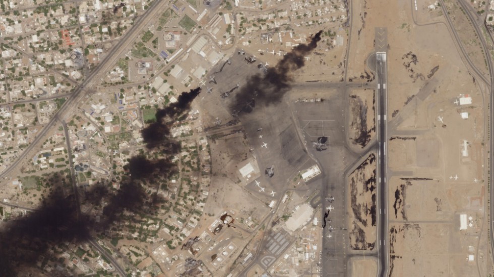 Denna satellitbild togs i onsdags och visar hur rök stiger från den internationella flygplasen i Khartum. Flera ambassader ligger i området strax västerut, däribland Sveriges.