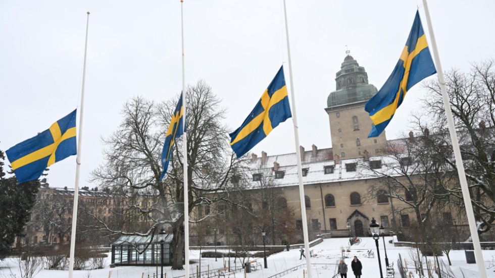 Flaggor på halv stång vid polishuset i Stockholm. Klockan 12 på torsdagen höll Polismyndigheten en tyst minut med anledning av Mats Löfvings bortgång.