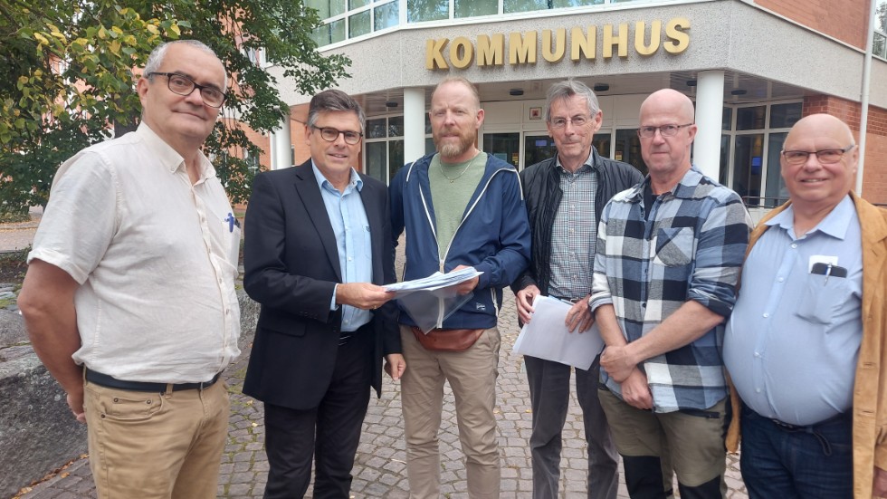 Oppositionsrådet Tomas Söreling och kommunalrådet Lars Rosander tar på fredagsmorgonen emot namnunderskrifterna av Håkan Danielsson, Bengt Roslund, Krister Karlsson, samt Claes Thunberg.
