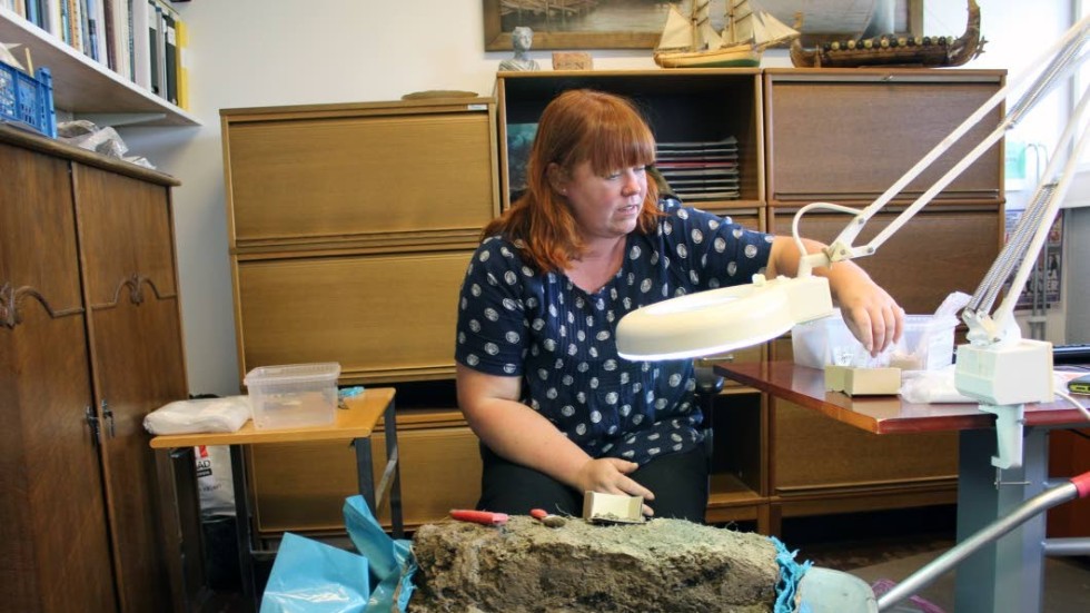 Arkeolog Veronica Palm har så smått börjat gräva ut den stora lerklumpen, som bland annat rymmer en skål.