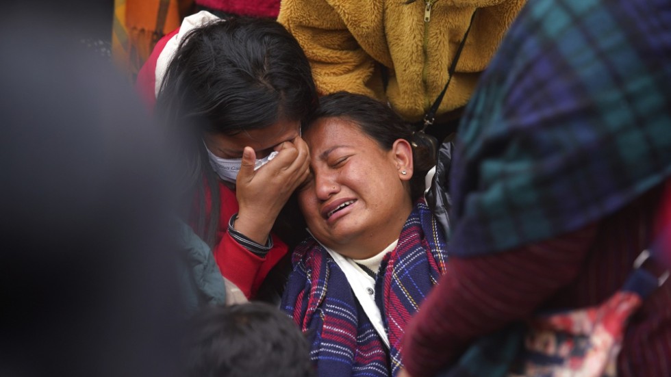 En kvinna gråter när kvarlevorna efter hennes släkting anländer till ett sjukhus i Pokhara efter söndagens flygkrasch.