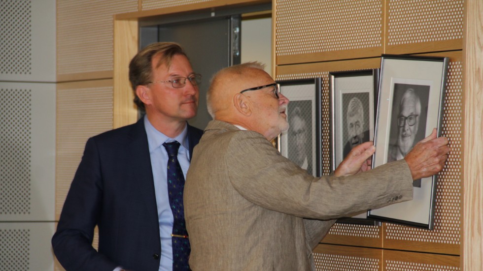 Under överinseende av nuvarande fullmäktigeordförande Klas Bergström hänger Kenneth Gunnar upp sitt porträtt på väggen bredvid sina föregångare Terry Carlbom och Göran Nilsson.