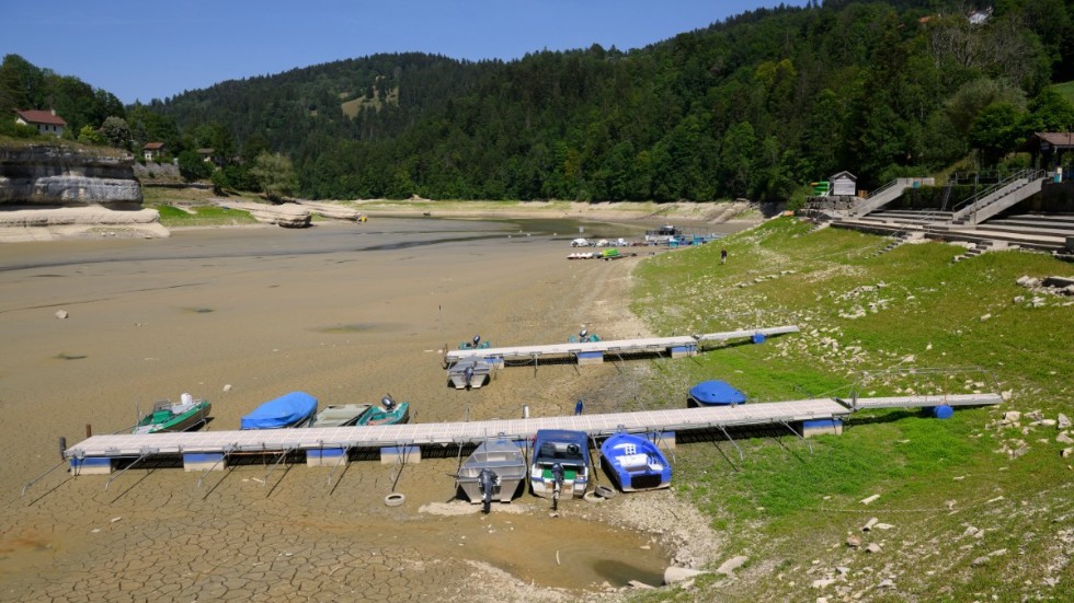 Strandade båtar i sjön Lac Brenet i västra Schweiz i mitten av juli. Vattennivån har sjunkit kraftigt i flera av landets mest kända sjöar.