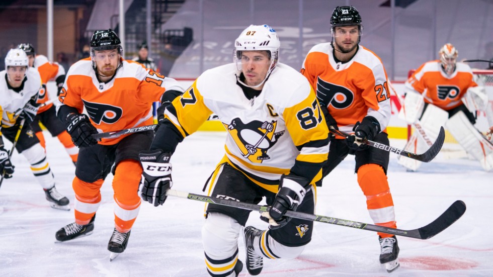 Pittsburgh Sidney Crosby, som var allra först på pucken i den nu inledda NHL-säsongen, jagas av Philadelphiaspelarna.