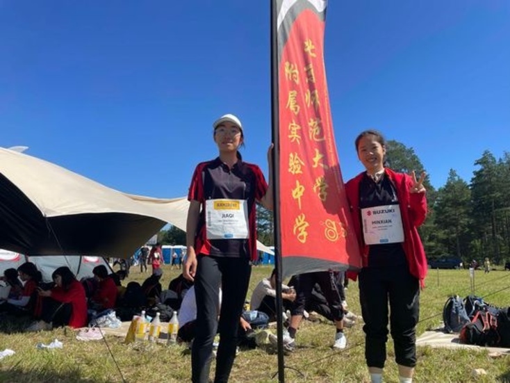 Jiaqi Lui och Minxian Liu från Beijing normal universitetet med skolans flagga.