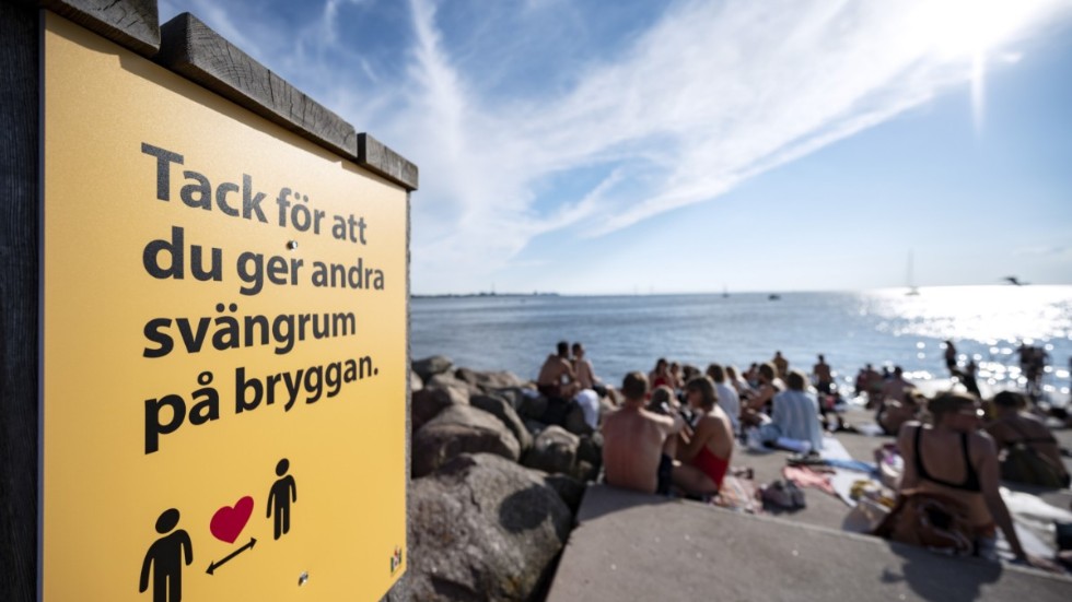 Många kommuner har satt upp skyltar, banderoller och flaggor för att försöka motverka trängsel på badplatserna. Här syns Sundspromenadens badbryggor i Malmö.