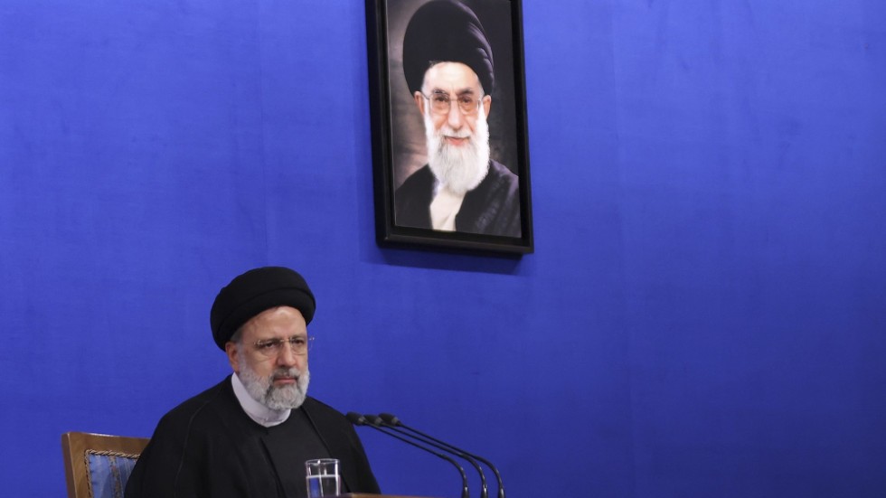 Ebrahim Raisi under ett porträtt på Ali Khamenei. Kommer Raisi ta över positionen som högste ledare?