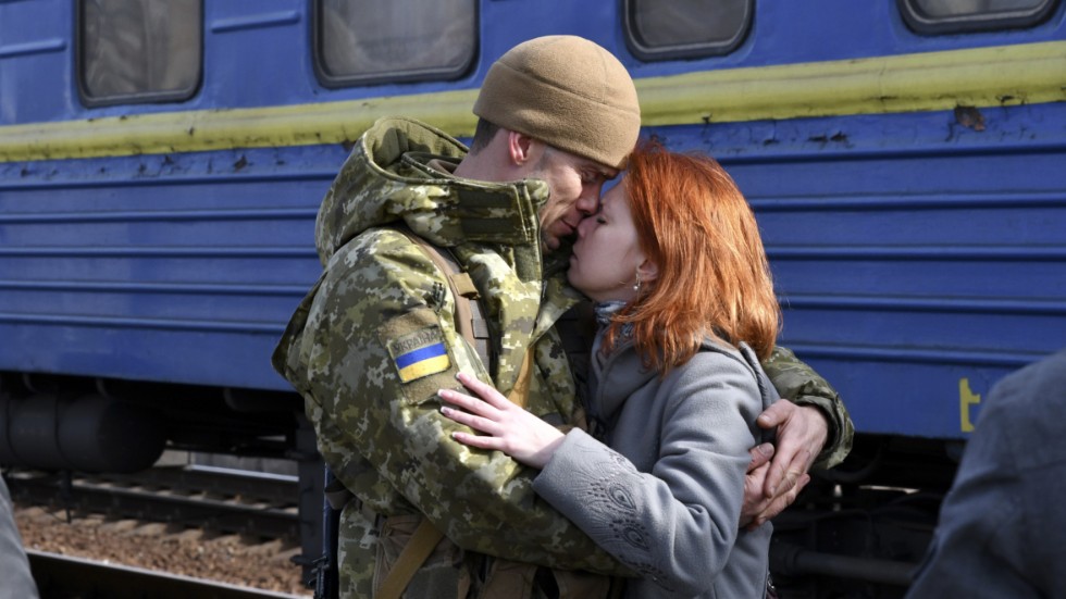 Ett par håller om varandra på perrongen i Kramatorsk, i östra Ukraina, innan kvinnan ska gå ombord ett tåg västerut, kort efter den ryska invasionen i februari 2022.